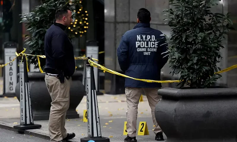 Law enforcement officers work near evidence markers placed where shell casings were found at the scene where the CEO of UnitedHealthcare Brian Thompson was shot and killed in Midtown Manhattan, in New York City, US, December 4, 2024.REUTERS/Shannon Stapleton/File Photo