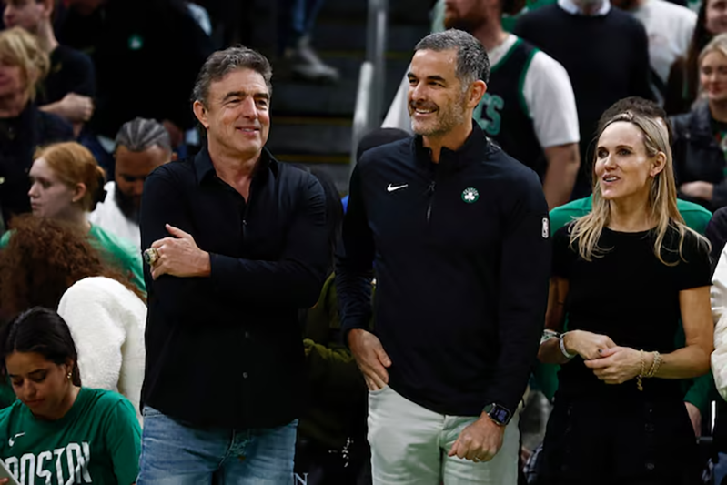 Bill Chisholm, center, who leads a group that is buying the Boston Celtics, stands with current owner Wyc Grousbeck and Chisholm’s wife, Kimberly Chisholm before the game between the Boston Celtics and the Phoenix Suns at TD Garden. Mandatory Credit: Winslow Townson-Imagn Images/File Photo
