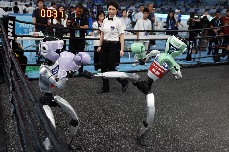 Unitree Robotics humanoid robots compete in a kickboxing match at the inaugural World Humanoid Robot Games, at the National Speed Skating Oval in Beijing, China August 15, 2025. REUTERS/Tingshu Wang