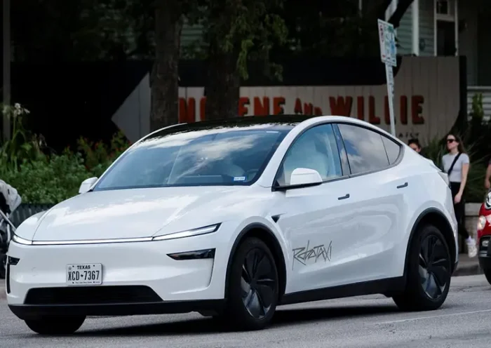A Tesla robotaxi drives on the street along South Congress Avenue in Austin, Texas, U.S., June 22, 2025. REUTERS/Joel Angel Juarez/File Photo