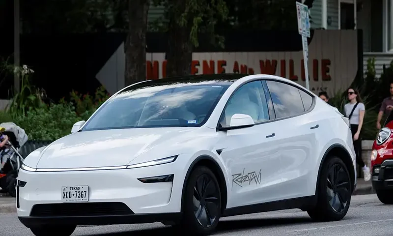 A Tesla robotaxi drives on the street along South Congress Avenue in Austin, Texas, U.S., June 22, 2025. REUTERS/Joel Angel Juarez/File Photo