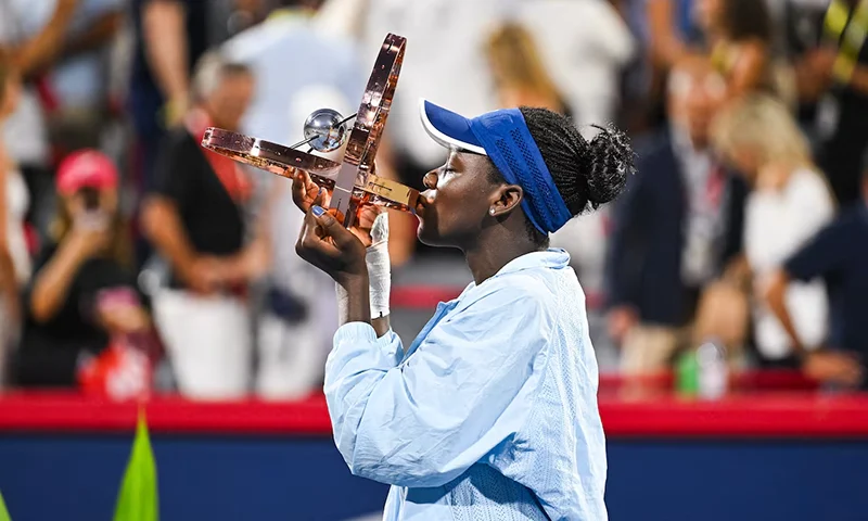 Victoria Mboko (CAN) tournament winner against Naomi Osaka (JPN) holds her trophy at IGA Stadium. Mandatory Credit: David Kirouac-Imagn Images