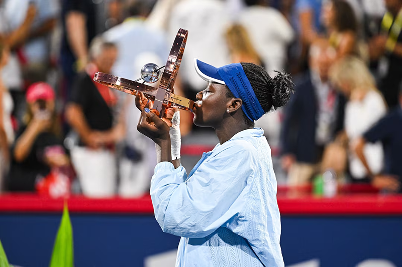 Victoria Mboko (CAN) tournament winner against Naomi Osaka (JPN) holds her trophy at IGA Stadium. Mandatory Credit: David Kirouac-Imagn Images
