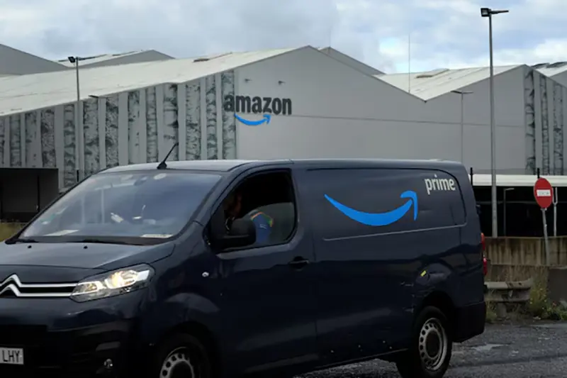 A van with the logo for Prime, a subscription service of U.S. online retailer Amazon, drives away from the company's logistics centre in Trapagaran, northern Spain, November 22, 2023. REUTERS/Vincent West/File Photo