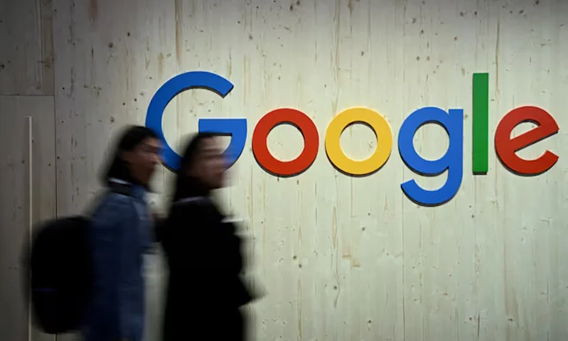 People walk next to a Google logo during a trade fair in Hannover Messe, in Hanover, Germany, April 22, 2024. REUTERS/Annegret Hilse/File Photo