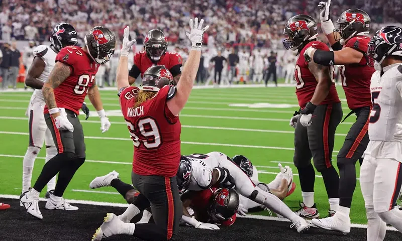 Tampa Bay Buccaneers guard Cody Mauch (69) celebrates as Tampa Bay Buccaneers running back Rachaad White (1) scores a touchdown during the fourth quarter against the Houston Texans at NRG Stadium. Mandatory Credit: Thomas Shea-Imagn Images