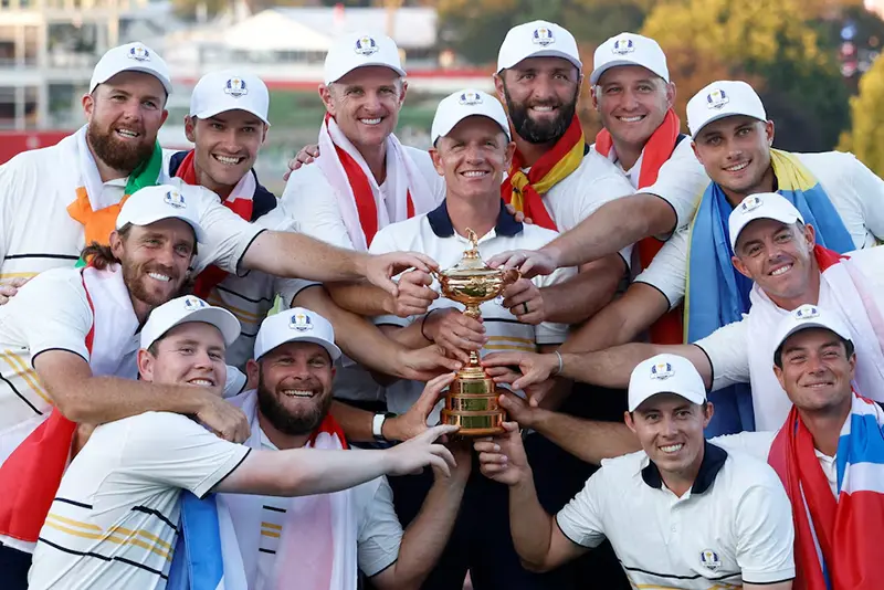Team Europe captain Luke Donald and his team pose with the trophy as they celebrate after winning the Ryder Cup REUTERS/Peter Casey