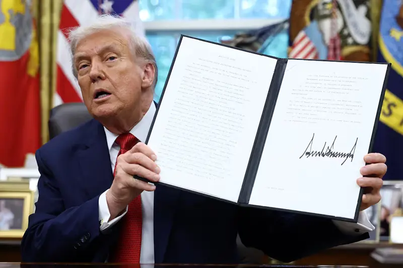 President Donald Trump shows a signed executive order on a deal that would divest TikTok's U.S. operations from ByteDance from its Chinese owner ByteDance, at the White House in Washington, D.C., U.S., September 25, 2025. REUTERS/Kevin Lamarque