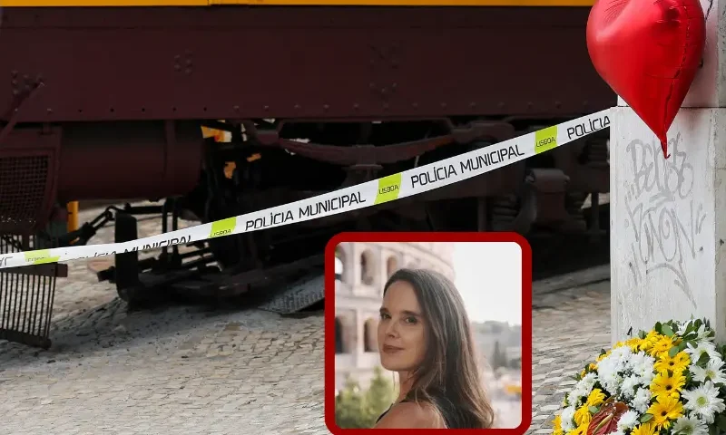 Flowers and a red-hearted balloon (R) in tribute to the victims are pictured the day after the Gloria funicular railway accident in Lisbon on September 4, 2025. Portugal held a day of national mourning on Thursday after one of Lisbon's famous funicular trains violently derailed and killed 16 people, including foreigners, and leaving five seriously injured. (Photo by PATRICIA DE MELO MOREIRA / AFP) (Photo by PATRICIA DE MELO MOREIRA/AFP via Getty Images)