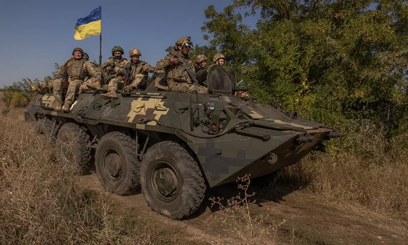 TOPSHOT - Ukrainian members of the OPFOR (opposing force) battalion ride on top of an armoured personnel carrier as they take part in a military training in the Donetsk region on September 26, 2023, amid the Russian invasion of Ukraine. (Photo by Roman PILIPEY / AFP) (Photo by ROMAN PILIPEY/AFP via Getty Images)