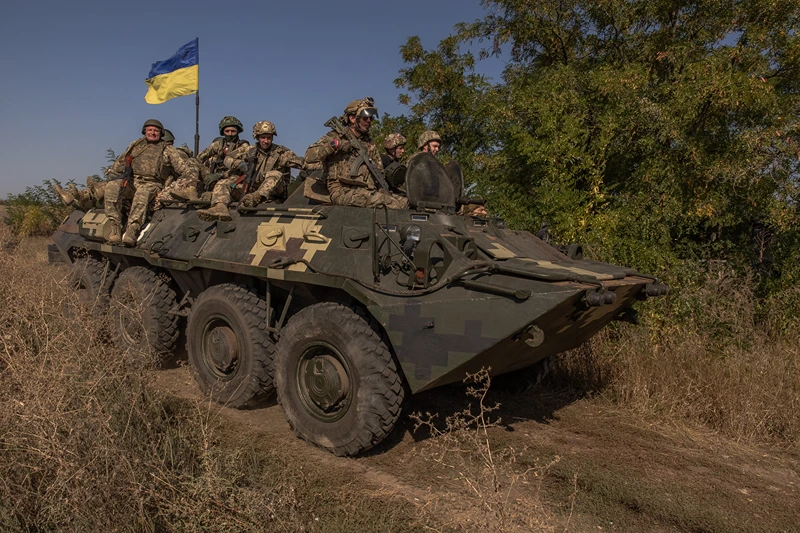 TOPSHOT - Ukrainian members of the OPFOR (opposing force) battalion ride on top of an armoured personnel carrier as they take part in a military training in the Donetsk region on September 26, 2023, amid the Russian invasion of Ukraine. (Photo by Roman PILIPEY / AFP) (Photo by ROMAN PILIPEY/AFP via Getty Images)