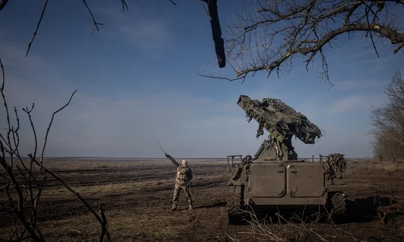 MARINKA, UKRAINE - FEBRUARY 23: A member of Ukraine's 72nd Brigade Anti-air unit points to the direction of a Russian Zala reconnaissance drone sighted overhead as they prepare to fire a Strela -10 anti-air missile system on February 23, 2024 near Marinka, Ukraine. February 24 will mark two years since Russia's large-scale invasion of Ukraine, which has left tens of thousands dead and many more wounded, although neither country releases official casualty figures. The war has also sparked economic insecurity around the world, further isolated Russia from the West, and, while initially galvanising NATO countries, has exposed tensions between Western allies over the scale and duration of military support to Ukraine. Two years on, the war shows no sign of ending, even while the frontlines have changed very little in recent months. (Photo by Chris McGrath/Getty Images)