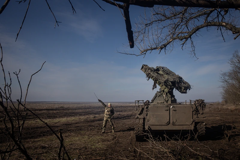MARINKA, UKRAINE - FEBRUARY 23: A member of Ukraine's 72nd Brigade Anti-air unit points to the direction of a Russian Zala reconnaissance drone sighted overhead as they prepare to fire a Strela -10 anti-air missile system on February 23, 2024 near Marinka, Ukraine. February 24 will mark two years since Russia's large-scale invasion of Ukraine, which has left tens of thousands dead and many more wounded, although neither country releases official casualty figures. The war has also sparked economic insecurity around the world, further isolated Russia from the West, and, while initially galvanising NATO countries, has exposed tensions between Western allies over the scale and duration of military support to Ukraine. Two years on, the war shows no sign of ending, even while the frontlines have changed very little in recent months. (Photo by Chris McGrath/Getty Images)