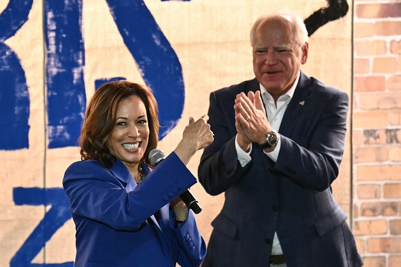 US Vice President and Democratic presidential candidate Kamala Harris (L) speaks as her running mate Minnesota Governor Tim Walz looks on during a stop on their campaign bus tour in Rochester, Pennsylvania, on August 18, 2024. Harris embarked on a bus tour of the potentially election-deciding state of Pennsylvania on Sunday, as she keeps up the momentum before her star turn at the Democratic National Convention in Chicago. (Photo by ANGELA WEISS / AFP) (Photo by ANGELA WEISS/AFP via Getty Images)