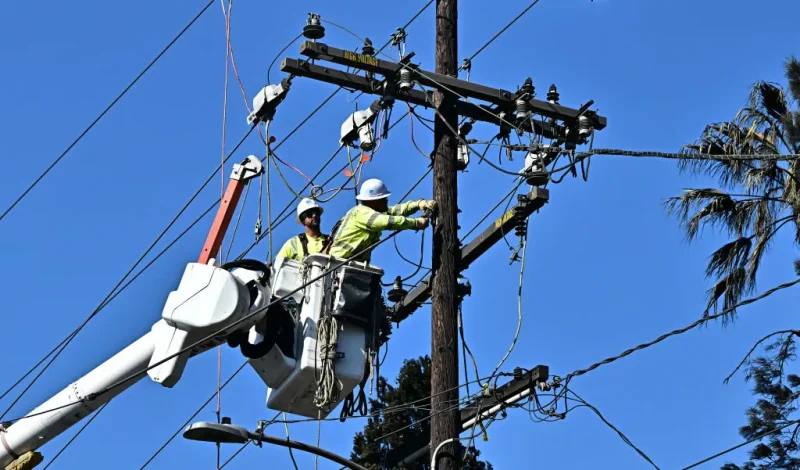Workers from PG&E work on repairing and restoring power lines on January 13, 2025 in Altadena, California, where the devastating Eaton Fire caused widespread damage. Homeowners and renters who lost their homes due to the fire are suing Southern California Edison, alleging the electrical utility that provides electricity to some 15 million people in a 50,000 square-mile area of Southern California failed to de-energize its electrical equipment despite the high wind and red flag warnings issues by the National Weather Service. (Photo by Frederic J. BROWN / AFP) (Photo by FREDERIC J. BROWN/AFP via Getty Images)