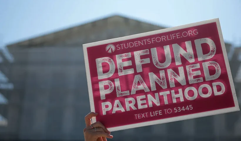 WASHINGTON, DC - JUNE 20: Protestors holding "Defund Planned Parenthood" signs stand outside of the U.S. Supreme Court on June 20, 2025 in Washington, DC. The Supreme Court began the morning with 16 cases to decide before the term ends and will end this week with 10 remaining. (Photo by Kayla Bartkowski/Getty Images)