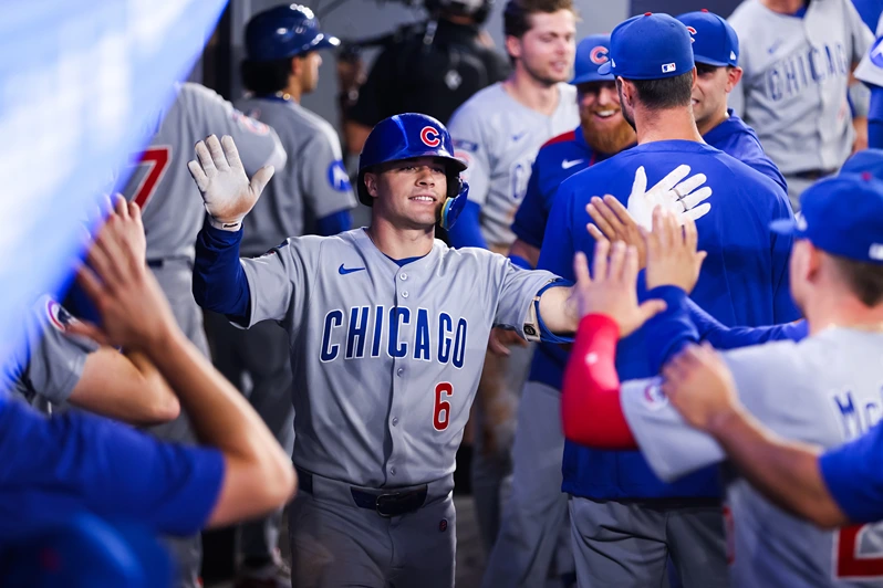 TORONTO, CANADA - AUGUST 13: Matt Shaw #6 of the Chicago Cubs celebrates in the dugout after hitting a solo-home run in the fifth inning of their MLB game against the Toronto Blue Jays at Rogers Centre on August 13, 2025 in Toronto, Ontario, Canada. (Photo by Cole Burston/Getty Images)