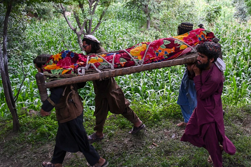 Graphic content / Afghans carry the deceased for funeral ceremony after earthquakes at Mazar Dara village in Nurgal district, Kunar province, in Eastern Afghanistan, on September 1, 2025. More than 800 people have died and over 2,700 were injured from August 31 night to September 1, 2025, in eastern Afghanistan after a 6-magnitude earthquake, followed by at least five aftershocks felt hundreds of kilometers away. (Photo by Wakil Kohsar / AFP) (Photo by WAKIL KOHSAR/AFP via Getty Images)