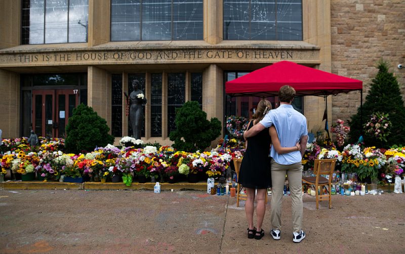 MINNEAPOLIS, MINNESOTA - SEPTEMBER 2: People embrace outside of Annunciation Church and School on September 2, 2025 in Minneapolis, Minnesota. The majority of Minnesota school children return to school today after last weeks mass shooting at Annunciation Church and School which killed two and injured 21 others.(Photo by Stephen Maturen/Getty Images)