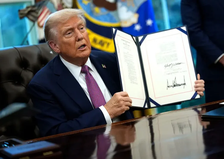WASHINGTON, DC - SEPTEMBER 05: U.S. President Donald Trump holds up the Homebuyers Privacy Protection Act after signing it into law, during a press availability in the Oval Office of the White House on September 05, 2025 in Washington, DC. President Trump signed a series of executive orders which included the renaming of the Department of Defense to the Department of War. (Photo by Kevin Dietsch/Getty Images)