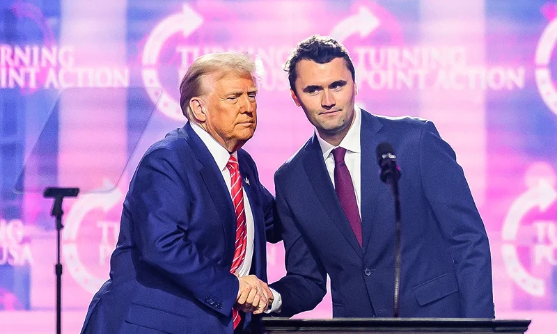 US right-wing activist Charlie Kirk (R) speaks on stage with President Donald Trump at America Fest 2024 in Phoenix, Arizona, on December 22, 2024. Right-wing youth activist and influencer Charlie Kirk, a major ally of President Donald Trump, was shot dead on September 10, 2025 in a murder that sparked fears of more political violence in an increasingly febrile United States. Trump confirmed on social media that Kirk, 31, had died from his injuries. (Photo by JOSH EDELSON / AFP) (Photo by JOSH EDELSON/AFP via Getty Images)