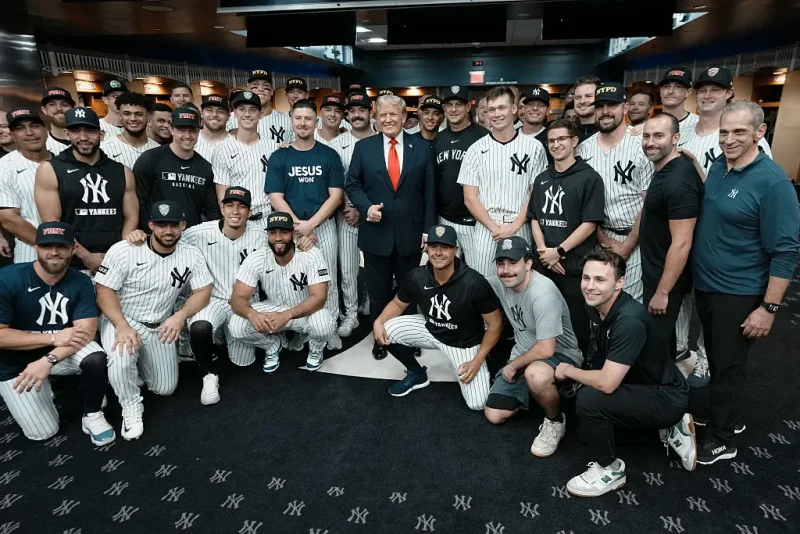 NEW YORK, NY - SEPTEMBER 11: U.S. President Donald Trump poses with members of the New York Yankees in the locker room before a game against the Detroit Tigers at Yankee Stadium on September 11, 2025 in New York City. (Photo by Doug Mills-Pool/Getty Images)