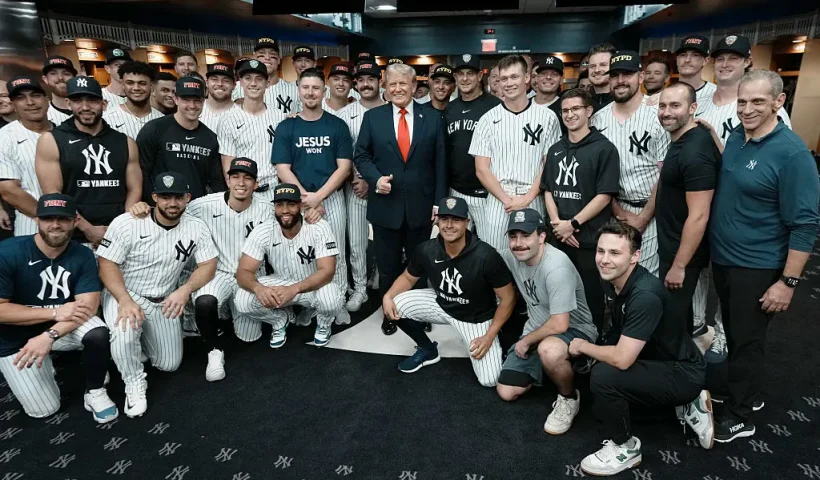 NEW YORK, NY - SEPTEMBER 11: U.S. President Donald Trump poses with members of the New York Yankees in the locker room before a game against the Detroit Tigers at Yankee Stadium on September 11, 2025 in New York City. (Photo by Doug Mills-Pool/Getty Images)