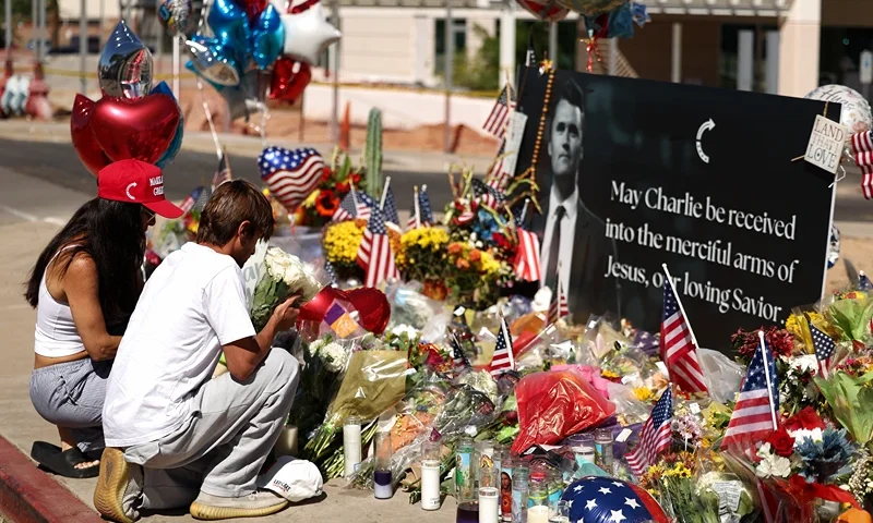 Arizonans mourn Turning Point USA Founder Charlie Kirk outside of the Turning Point USA headquarters on September 12, 2025 in Phoenix, Arizona. US President Donald Trump on Friday announced that the suspect had been taken into custody over the killing of right-wing activist Charlie Kirk after a massive manhunt. (Photo by CHARLY TRIBALLEAU / AFP) (Photo by CHARLY TRIBALLEAU/AFP via Getty Images)