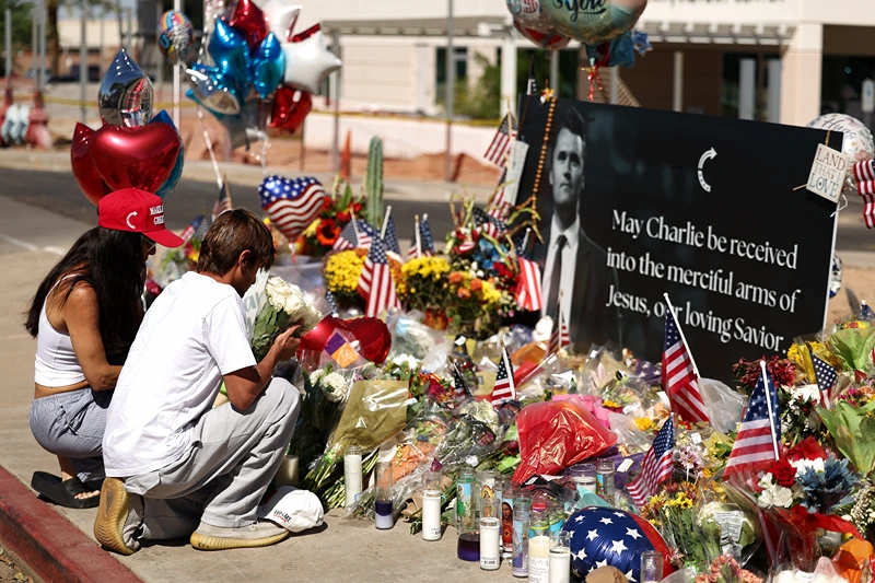 Arizonans mourn Turning Point USA Founder Charlie Kirk outside of the Turning Point USA headquarters on September 12, 2025 in Phoenix, Arizona. US President Donald Trump on Friday announced that the suspect had been taken into custody over the killing of right-wing activist Charlie Kirk after a massive manhunt. (Photo by CHARLY TRIBALLEAU / AFP) (Photo by CHARLY TRIBALLEAU/AFP via Getty Images)