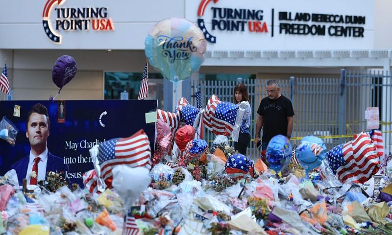 PHOENIX, ARIZONA - SEPTEMBER 18: People visit the makeshift memorial for Charlie Kirk outside the headquarters of Turning Point USA on September 18, 2025, in Phoenix, Arizona. Kirk, the CEO and co-founder of Turning Point USA, was shot and killed on September 10th while speaking at an event for his "American Comeback Tour" at Utah Valley University. (Photo by Joe Raedle/Getty Images)