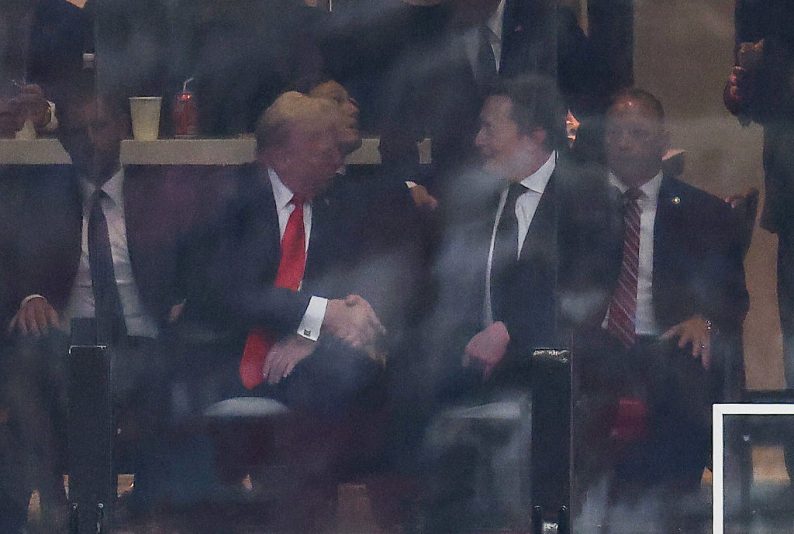 US President Donald Trump and Tesla CEO Elon Musk shake hands during the public memorial service for right-wing activist Charlie Kirk at State Farm Stadium in Glendale, Arizona, on September 21, 2025. (Photo by CHARLY TRIBALLEAU / AFP) (Photo by CHARLY TRIBALLEAU/AFP via Getty Images)