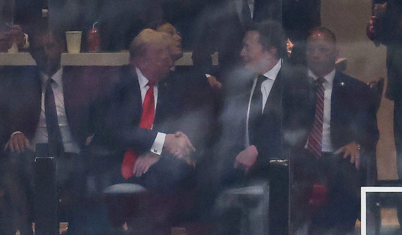 US President Donald Trump and Tesla CEO Elon Musk shake hands during the public memorial service for right-wing activist Charlie Kirk at State Farm Stadium in Glendale, Arizona, on September 21, 2025. (Photo by CHARLY TRIBALLEAU / AFP) (Photo by CHARLY TRIBALLEAU/AFP via Getty Images)