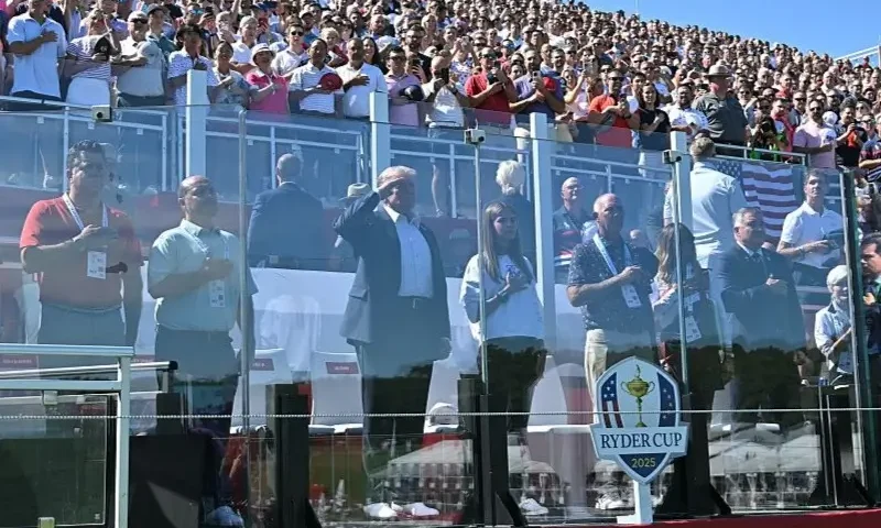 U.S. President Donald Trump, along with his granddaughter Kai Madison Trump, attends the 2025 Ryder Cup at Black Course at Bethpage State Park Golf Course on September 26, 2025 in Farmingdale, New York. In his second term, Trump has attended several major sporting events. (Photo by Mandel Ngan-Pool/Getty Images)