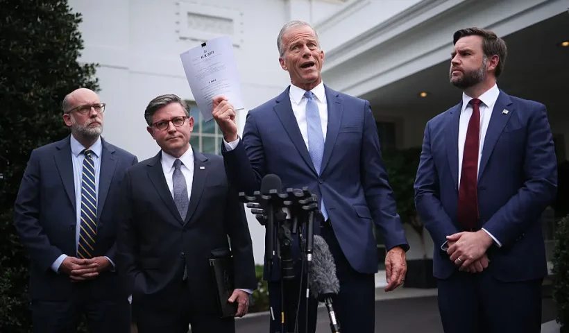 WASHINGTON, DC - SEPTEMBER 29: U.S. Senate Majority Leader John Thune (R-SD) delivers remarks and holds up a copy of a "clean CR" following a meeting with Congressional Democrats and U.S. President Donald Trump at the White House on September 29, 2025 in Washington, DC. Congressional leaders met with President Trump to negotiate funding legislation to avoid a government shutdown. Thune was accompanied by (L-R) Director of the Office of Management and Budget Russell Vought, Speaker of the House Mike Johnson (R-LA) and Vice President JD Vance. (Photo by Win McNamee/Getty Images)