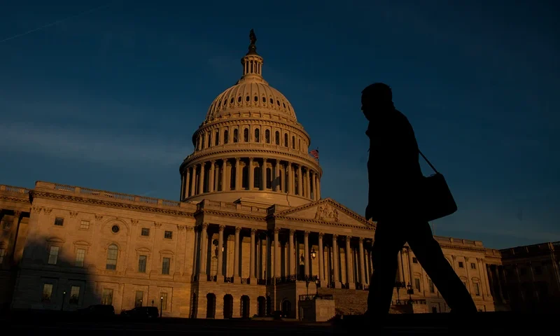 WASHINGTON, D.C. - MARCH 20: A person walks by as the sun rises near The United States Capitol Building on March 20, 2017 in Washington, D.C. The Senate will hold a confirmation hearing for Supreme Court Nominee Neil Gorsuch and FBI Director James Comey will testify before the House Permanent Select Committee on Intelligence on alleged Russian interference in the 2016 election. (Photo by Zach Gibson/Getty Images)