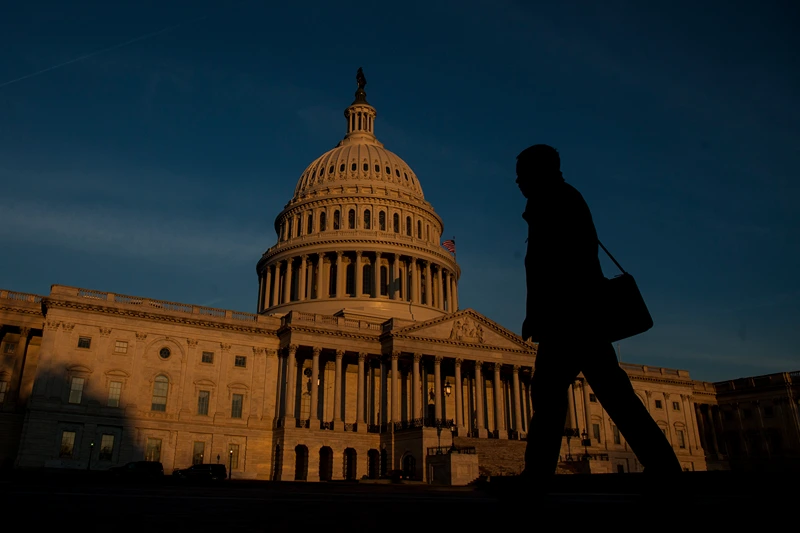 WASHINGTON, D.C. - MARCH 20: A person walks by as the sun rises near The United States Capitol Building on March 20, 2017 in Washington, D.C. The Senate will hold a confirmation hearing for Supreme Court Nominee Neil Gorsuch and FBI Director James Comey will testify before the House Permanent Select Committee on Intelligence on alleged Russian interference in the 2016 election. (Photo by Zach Gibson/Getty Images)