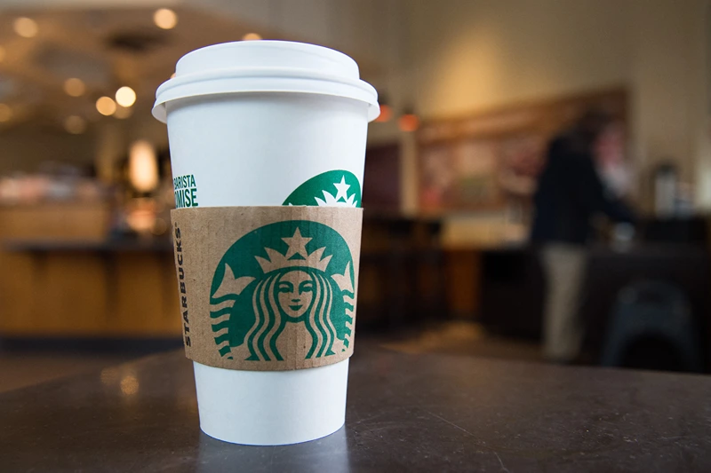 A Starbucks coffee cup is seen inside a Starbucks Coffee shop in Washington, DC, April 17, 2018, following the company's announcement that they will close more than 8,000 US stores on May 29 to conduct "racial-bias education" following the arrest of two black men in one of its cafes. (Photo by SAUL LOEB / AFP) (Photo by SAUL LOEB/AFP via Getty Images)