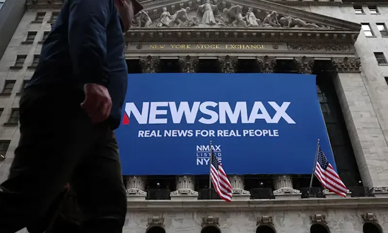A banner for Newsmax Inc. is displayed during the company’s IPO at the New York Stock Exchange (NYSE) in New York City, U.S., March 31, 2025. REUTERS/Brendan McDermid/File Photo