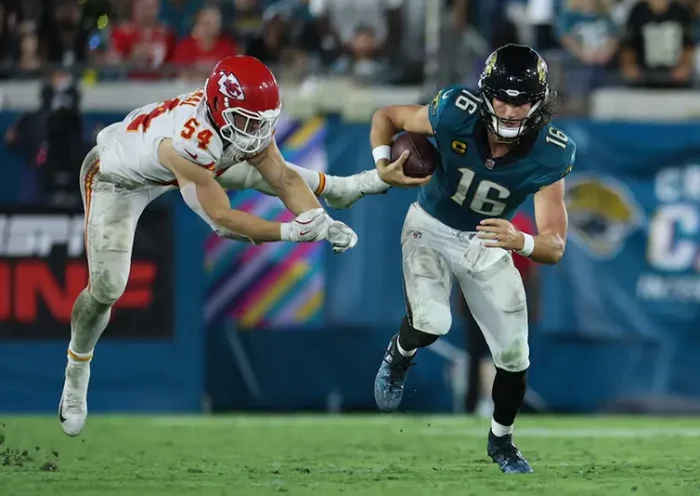 Jacksonville Jaguars quarterback Trevor Lawrence (16) runs against Kansas City Chiefs linebacker Leo Chenal (54) during the second half at EverBank Stadium. Mandatory Credit: Nathan Ray Seebeck-Imagn Images