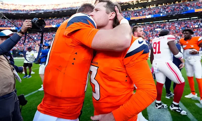 Denver Broncos kicker Wil Lutz (3) and Denver Broncos quarterback Bo Nix (10) celebrate after the win against the New York Giants at Empower Field at Mile High. Mandatory Credit: Ron Chenoy-Imagn Images