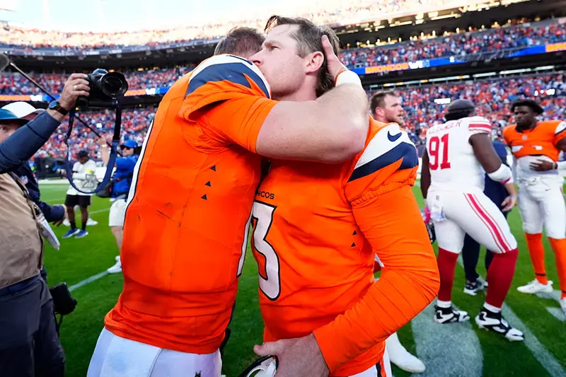 Denver Broncos kicker Wil Lutz (3) and Denver Broncos quarterback Bo Nix (10) celebrate after the win against the New York Giants at Empower Field at Mile High. Mandatory Credit: Ron Chenoy-Imagn Images