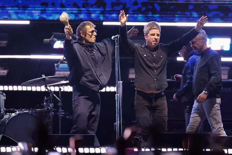 Liam Gallagher and Noel Gallagher from the British rock band Oasis, react during their Oasis Live '25 Tour at the Rose Bowl Stadium in Pasadena, California, U.S., September 6, 2025. REUTERS/Mario Anzuoni/File Photo