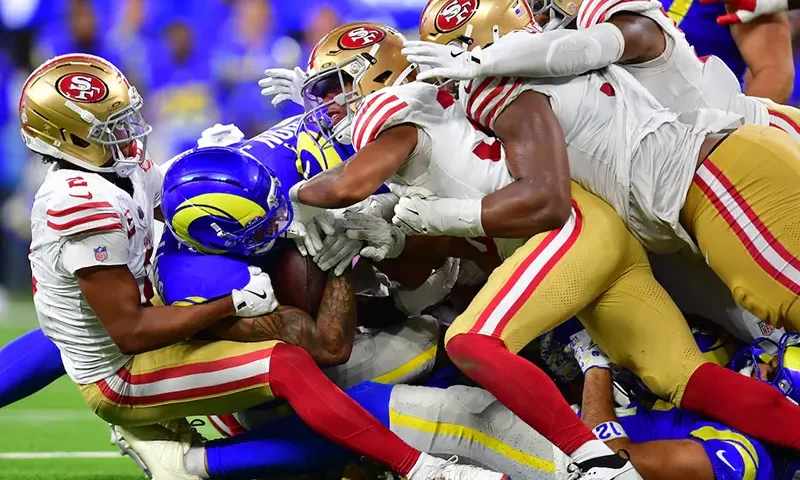 Los Angeles Rams running back Kyren Williams (23) is tackled for no gain on fourth down to end the game against the San Francisco 49ers during overtime at SoFi Stadium. Mandatory Credit: Gary A. Vasquez-Imagn Images
