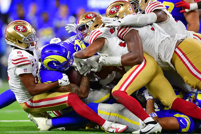 Los Angeles Rams running back Kyren Williams (23) is tackled for no gain on fourth down to end the game against the San Francisco 49ers during overtime at SoFi Stadium. Mandatory Credit: Gary A. Vasquez-Imagn Images