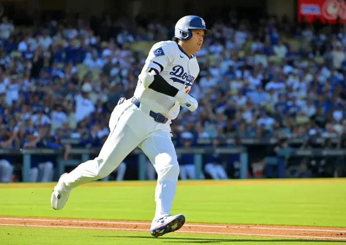 Los Angeles Dodgers two-way player Shohei Ohtani (17) runs after hitting a triple against the Milwaukee Brewers in the first inning during game three of the NLCS round for the 2025 MLB playoffs at Dodger Stadium. Mandatory Credit: Jayne Kamin-Oncea-Imagn Images