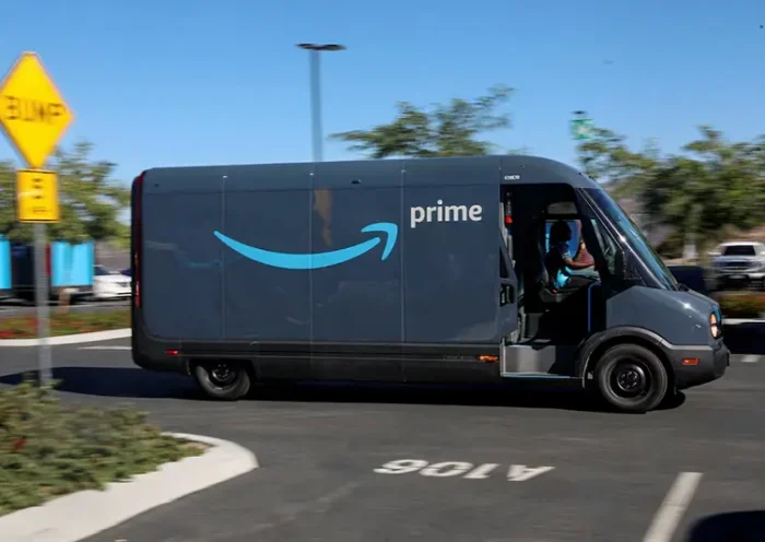 An electric Rivian truck purchased by Amazon is pictured working on delivery from the Amazon facility in Poway, California, U.S., November 16, 2022. REUTERS/Sandy Huffaker/File Photo