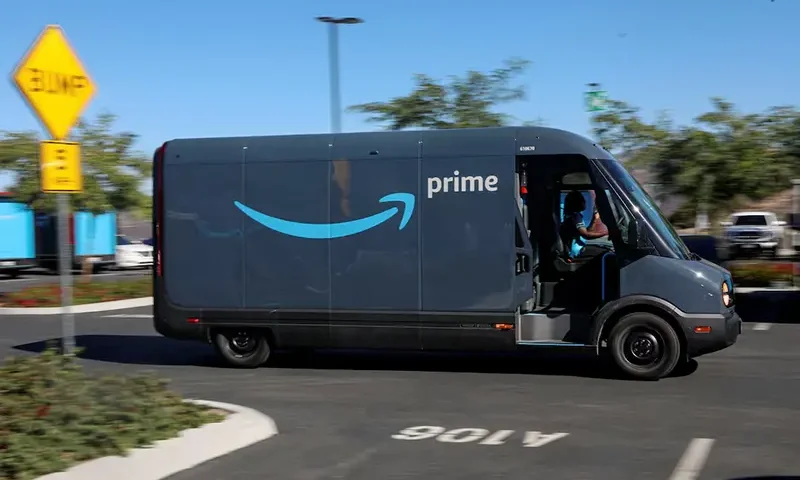 An electric Rivian truck purchased by Amazon is pictured working on delivery from the Amazon facility in Poway, California, U.S., November 16, 2022. REUTERS/Sandy Huffaker/File Photo