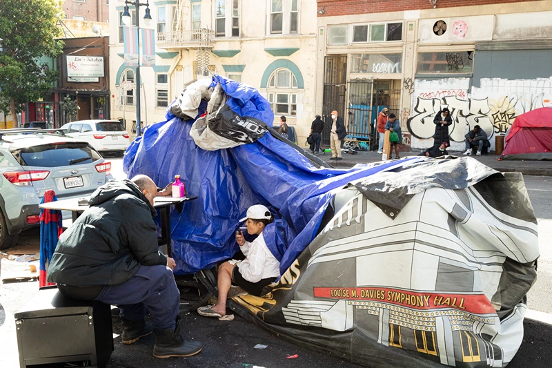 People and their belongings are seen on Jones Street in San Francisco, on November 13, 2023. San Francisco has struggled to clean up the city ahead of hosting world and business leaders. (Photo by Jason Henry / AFP) (Photo by JASON HENRY/AFP via Getty Images)