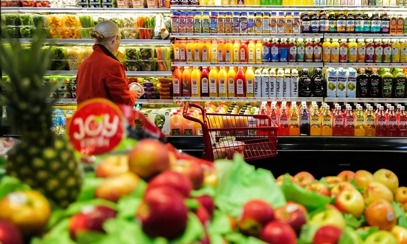 Fruit is displayed as a woman shops in a supermarket in the Manhattan borough of New York city on January 27, 2024. (Photo by Charly TRIBALLEAU / AFP) (Photo by CHARLY TRIBALLEAU/AFP via Getty Images)