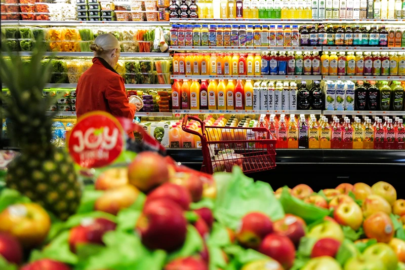 Fruit is displayed as a woman shops in a supermarket in the Manhattan borough of New York city on January 27, 2024. (Photo by Charly TRIBALLEAU / AFP) (Photo by CHARLY TRIBALLEAU/AFP via Getty Images)
